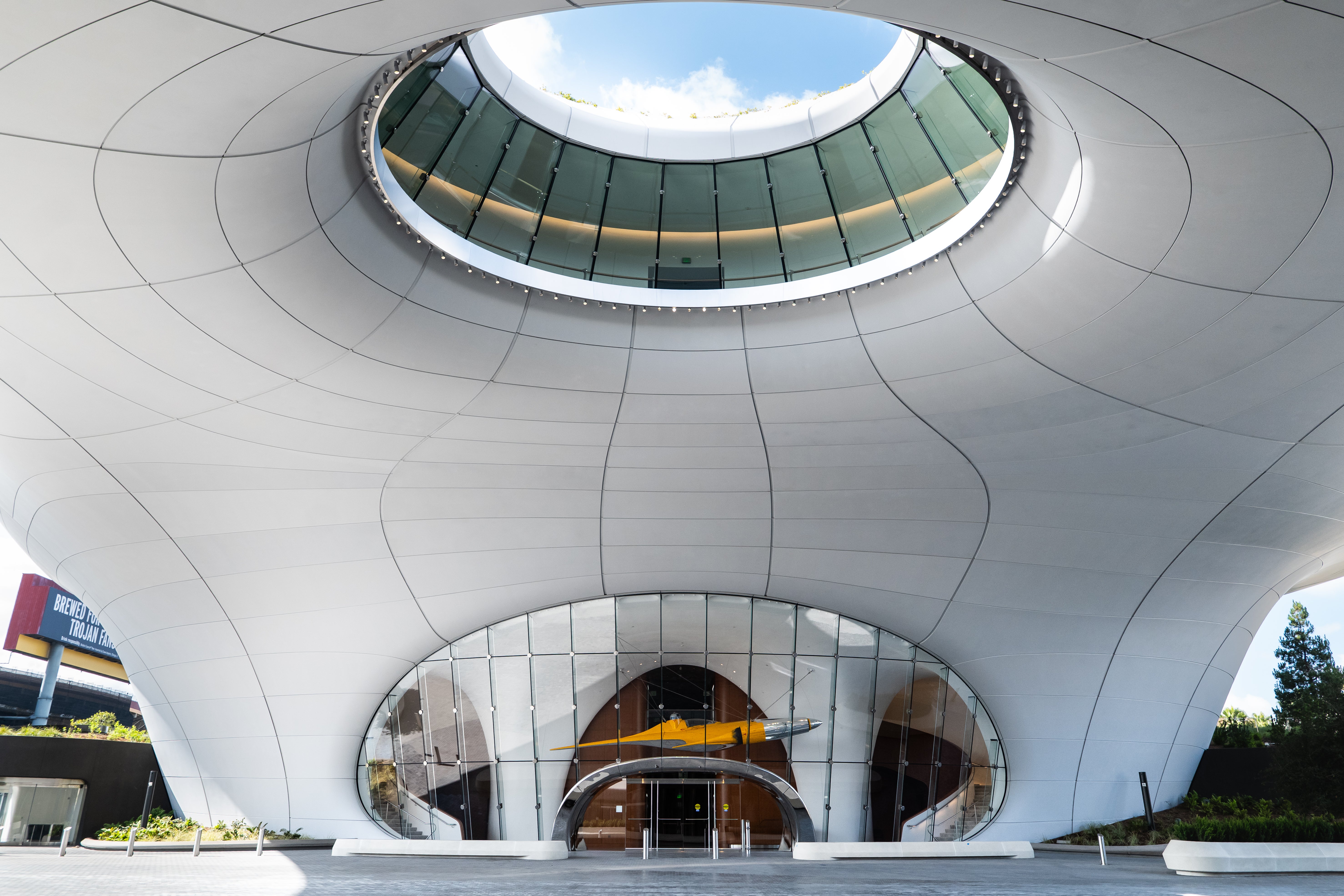 A view of Lucas Museum's South Lobby with the Naboo Starfighter visible through the glass